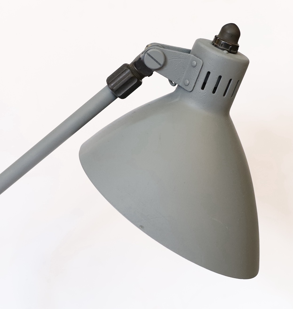 A 1950s Swiss enamelled and painted metal anglepoise lamp, height 56cm to the bend